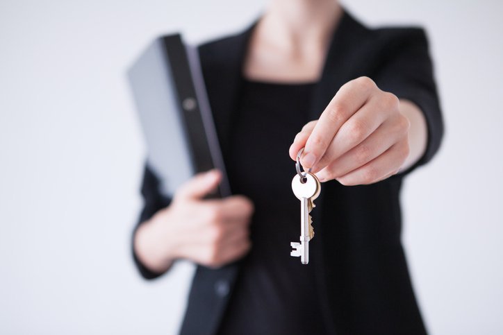 business woman handing over keys
