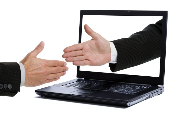handshake through laptop monitor